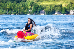 Happyyounggirlspeedsacrossalakeonaninflatableonasummerday.png